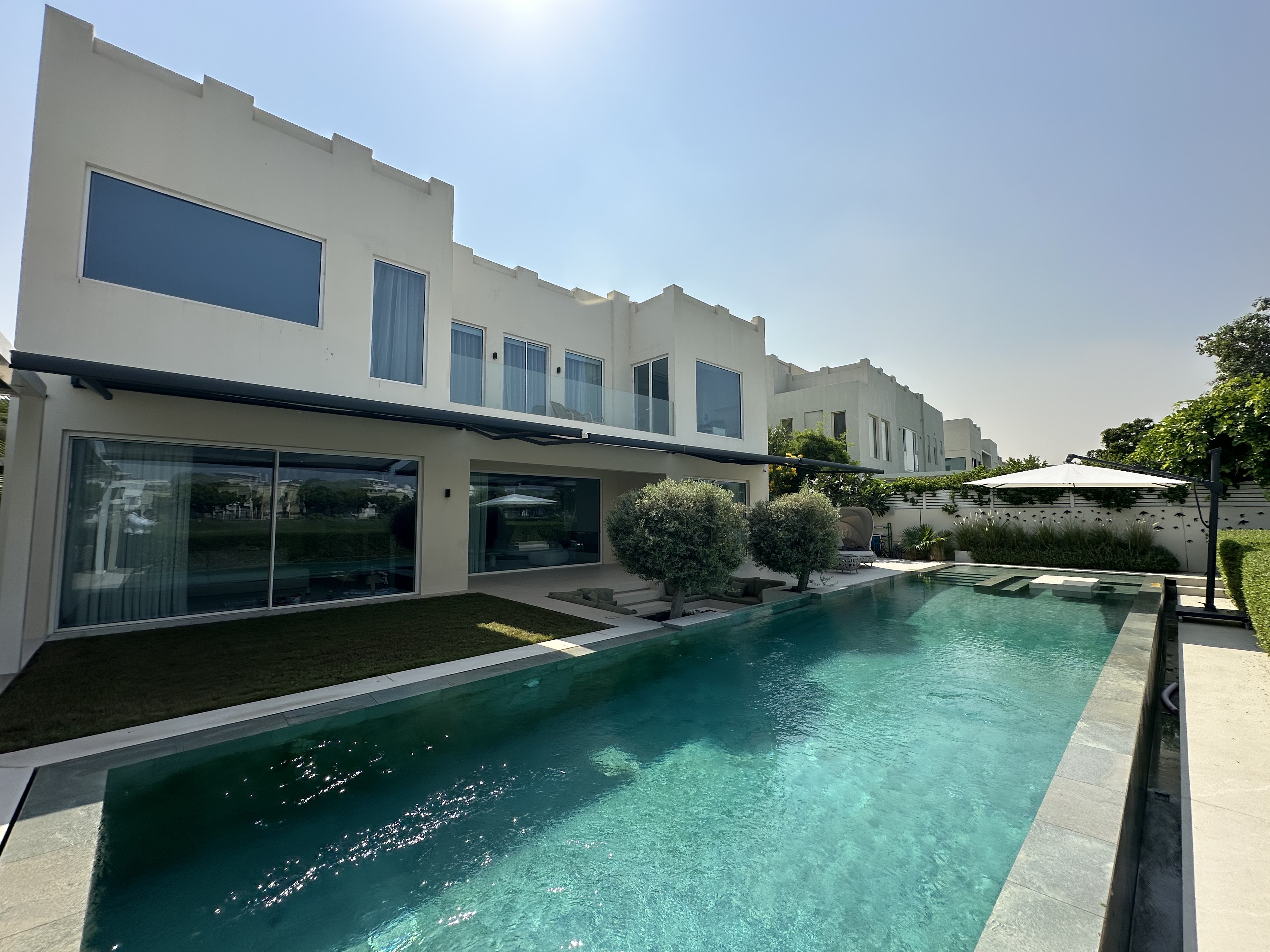 Villa exterior with retractable awning and pool in Meadows, Dubai